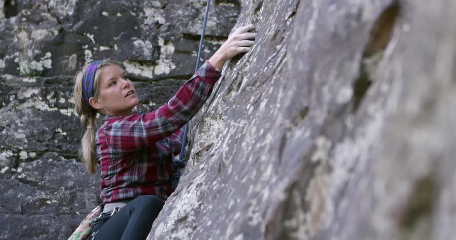 A woman is rock climbing