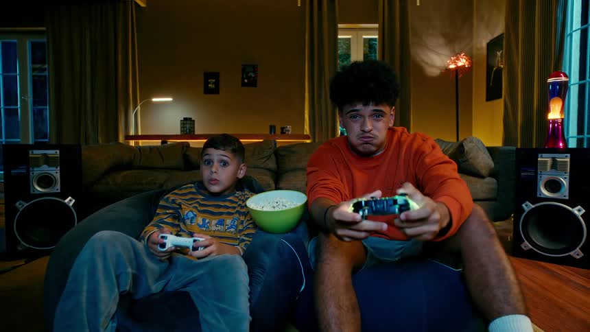A clip of brothers having fun with video game