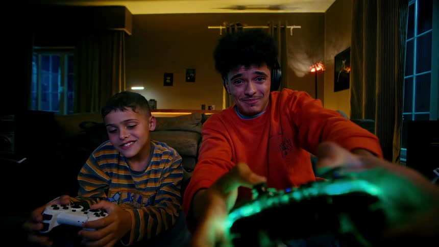 Little boy beating a teenager in a video game match