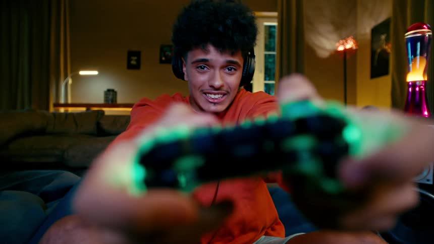 A young man gets into playing a videogame and then collapses with disgust when something bad in the game happens