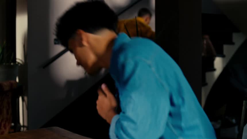 A father and son have a arm wrestling match