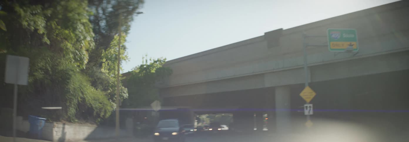 Moving view of a road and an overpass with vehicle traffic through the city