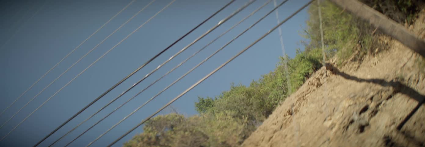 Power poles on a wooded hill