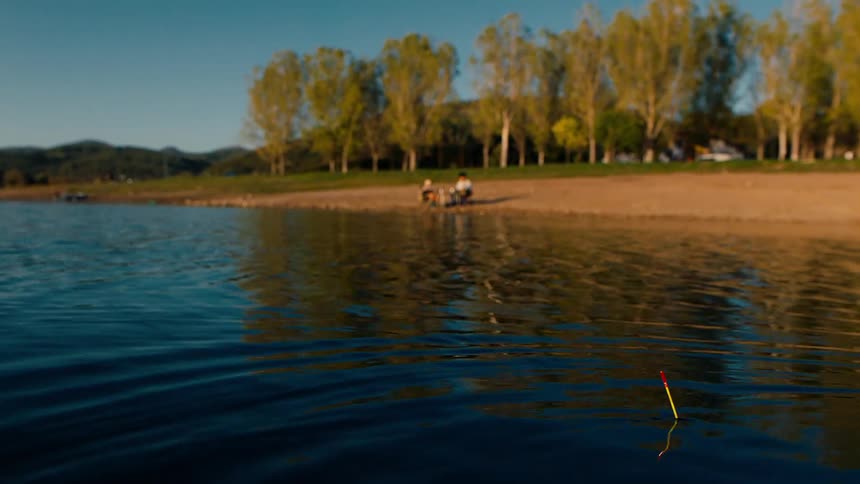 Two people are fishing in the lake