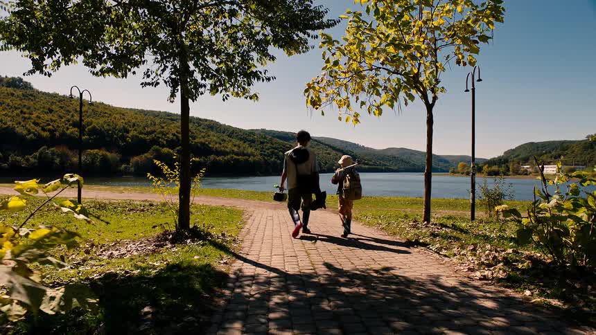 Campers walk down the path with their equipment