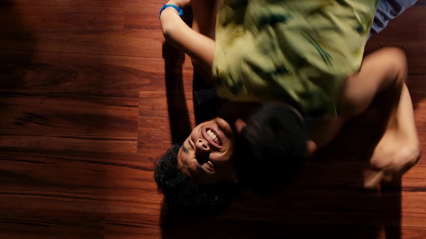 A clip of two brothers laughing on the floor