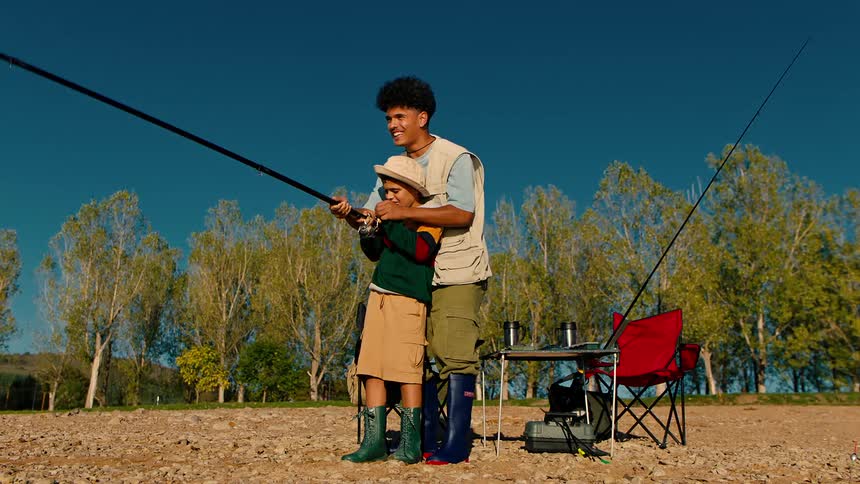 Relatives reel in a fish together