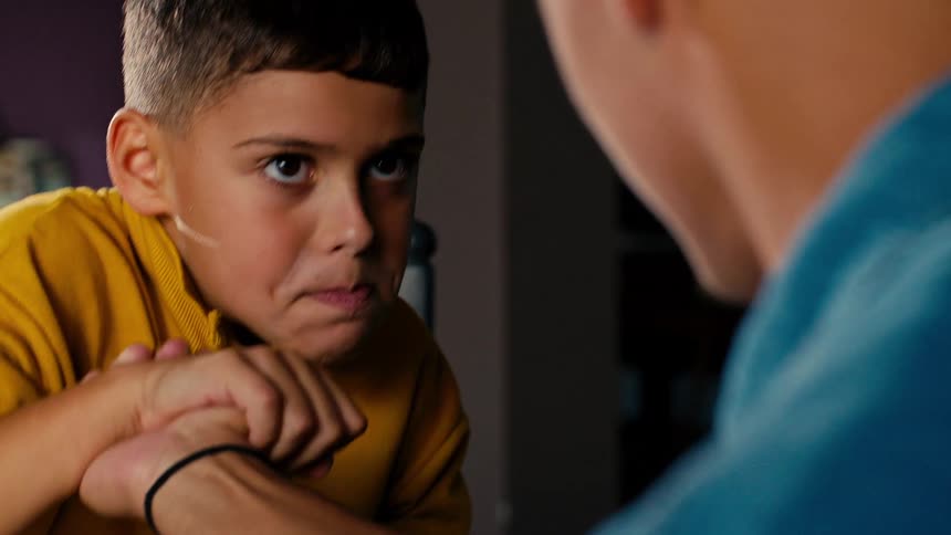 A father and son arm wrestle