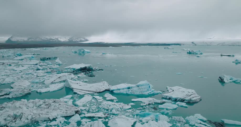 Chunks of ice float near a coastal area