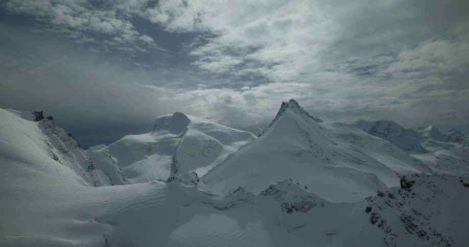 Aerial view of mountain ranges seen during the day and covered in snow