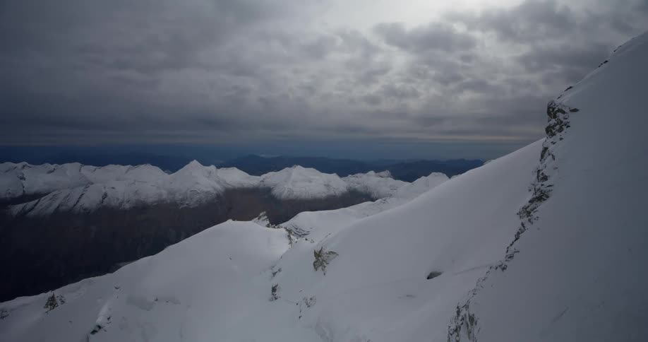 Aerial panorama of snowcapped mountain ranges on a cloudy day