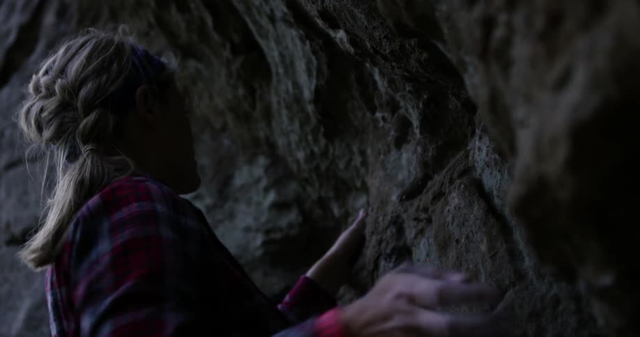 Woman rock climber using her skills