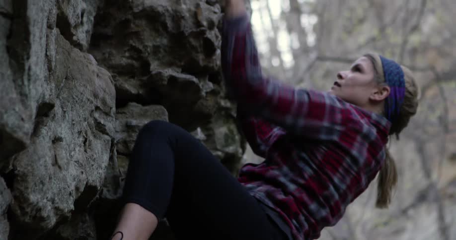 A woman is freestyle rock climbing