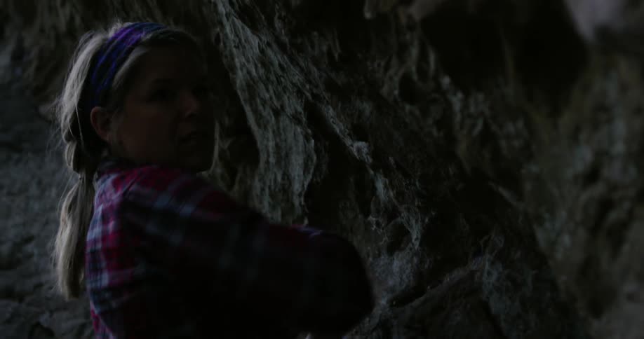 A woman is rock climbing