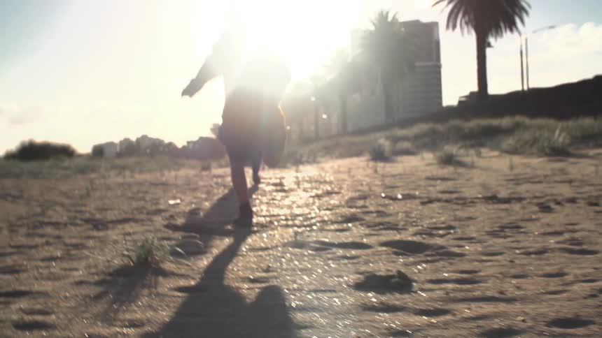 Children running on the beach on a sunny day