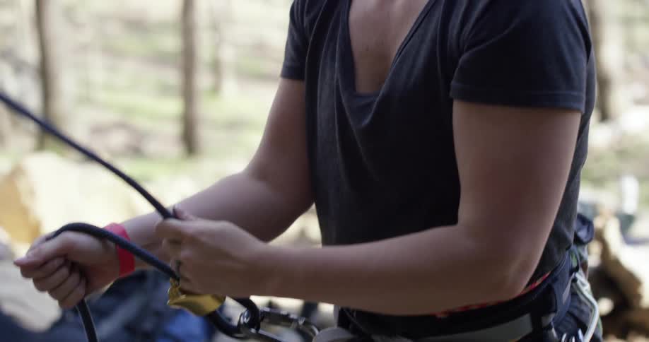A person pulling on rope that is hooked to a buckle around their waist