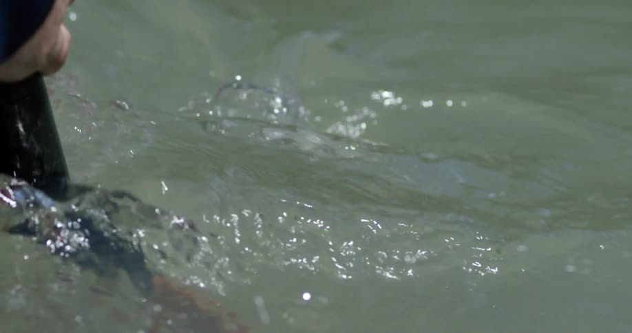 Extreme close-up of a kayakers paddle  entering the water
