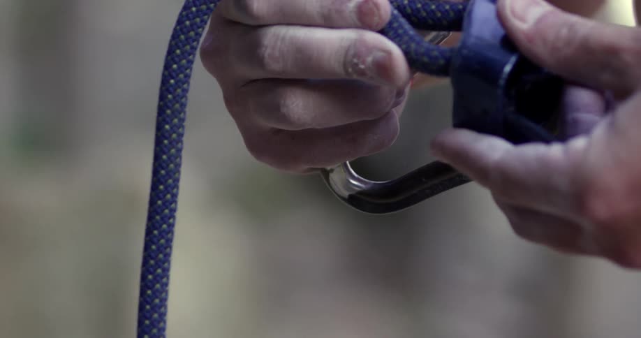 A person puts a rope in a latch