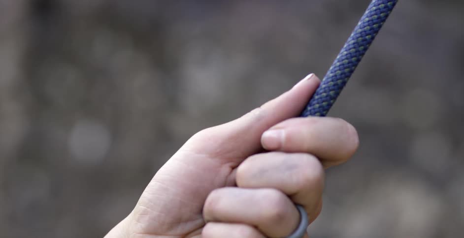 A woman is holding onto a rope