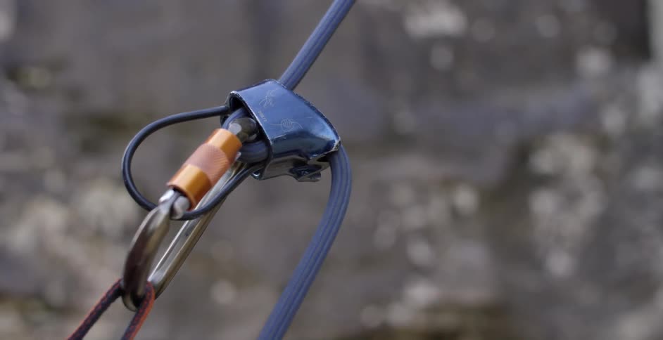 A rope is pulled through a metal clip