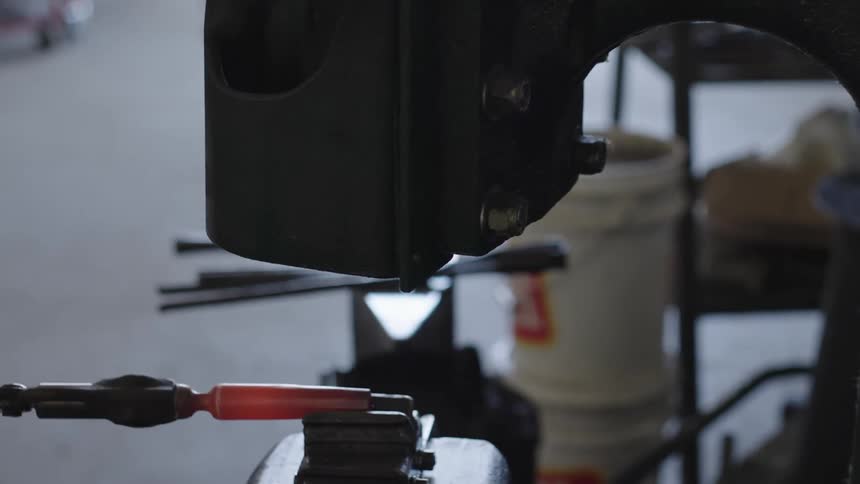 Machine hammering a hot iron