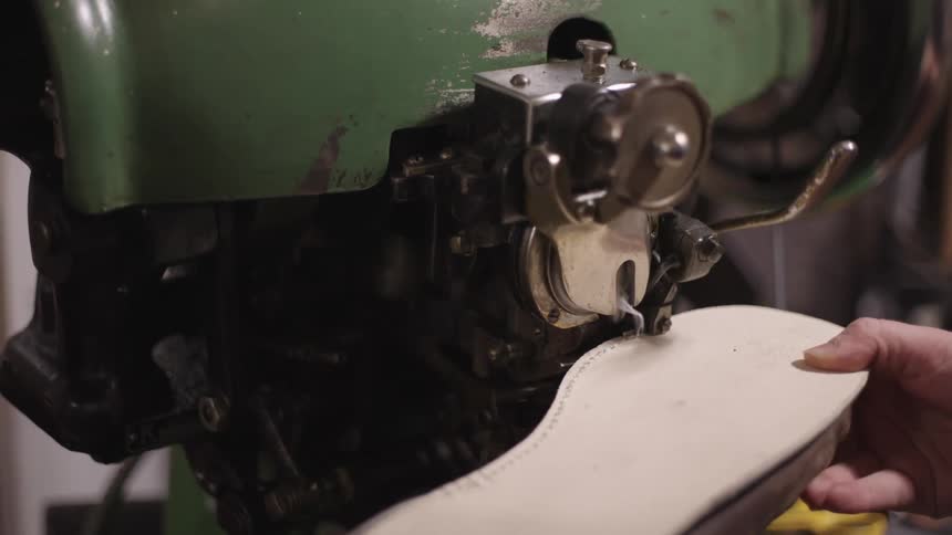Machine sewing a shoe