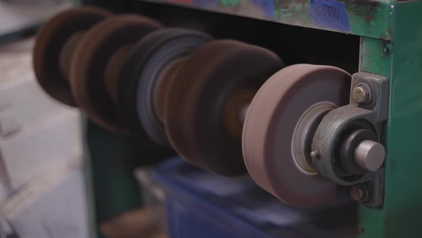 Person turning off a machine in a factory