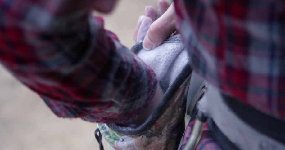A man is reaching into a pouch for some powder