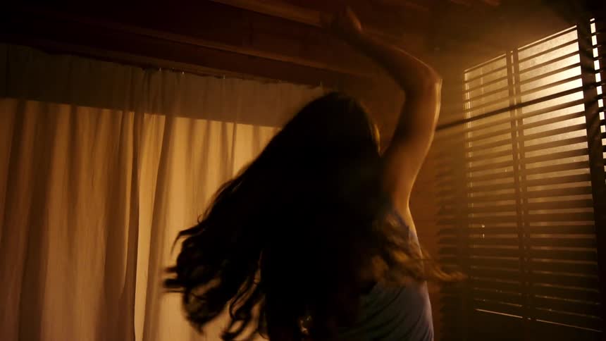 Woman dancing alone in living room