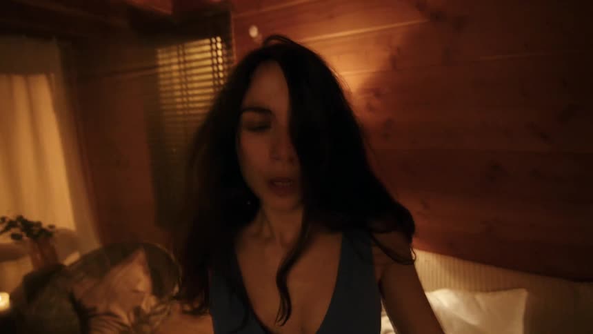Portrait of a woman in a living room at night standing