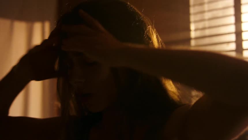 A young woman dancing by herself on a room