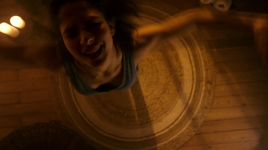 Woman in a room spinning while dancing