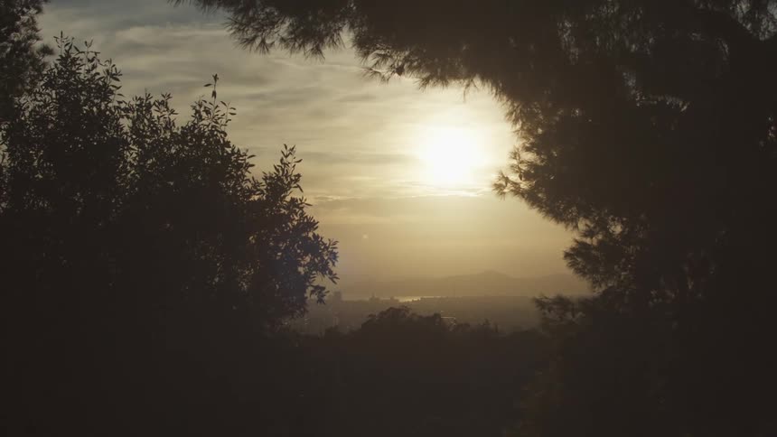 Diffused sunlight shines through the fog onto an obscured landscape