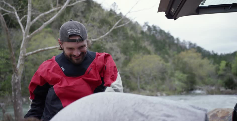Two men  unpacking gear from their vehicle