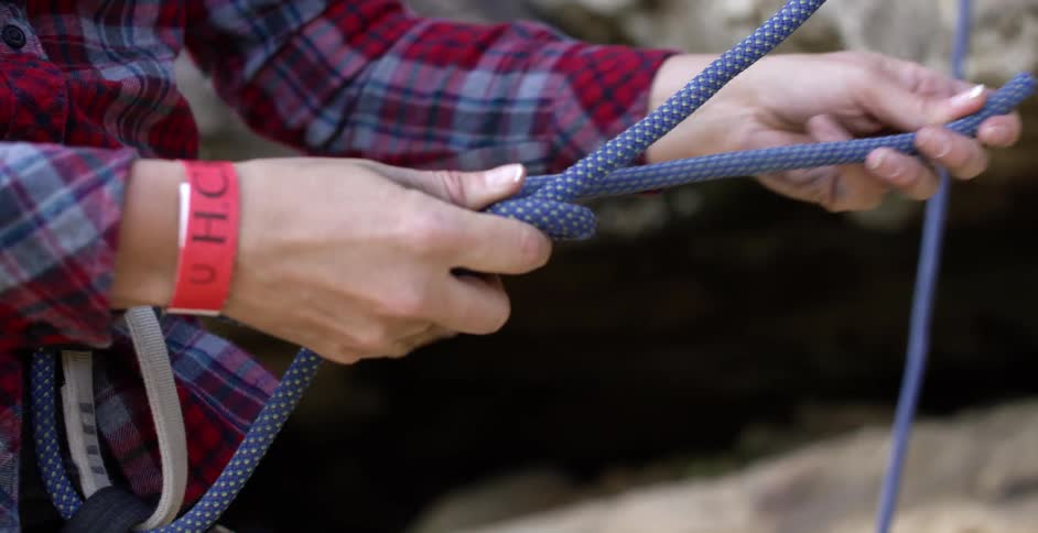 A woman tying a rope