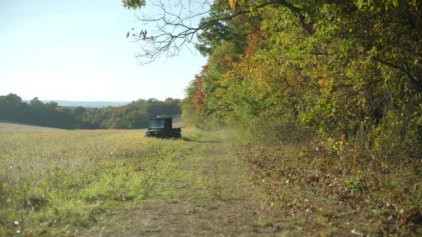 Car parking in a field and a man getting out