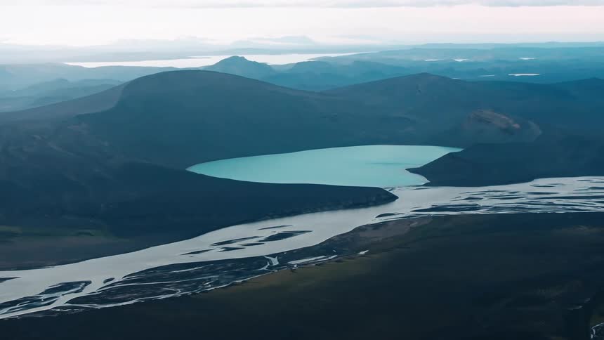 A glacierfed river winds its way through a frozen landscape