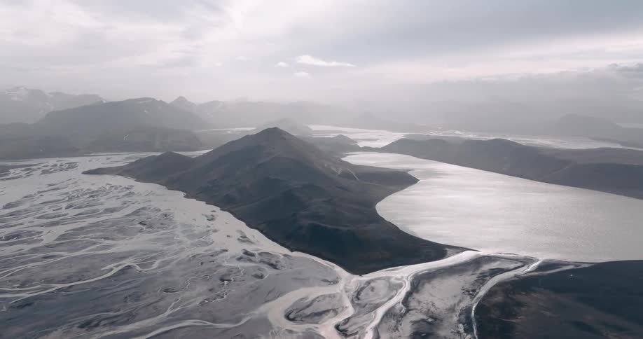 Aerial landscape of a watermarked land with hills and mountains and a lake in the background