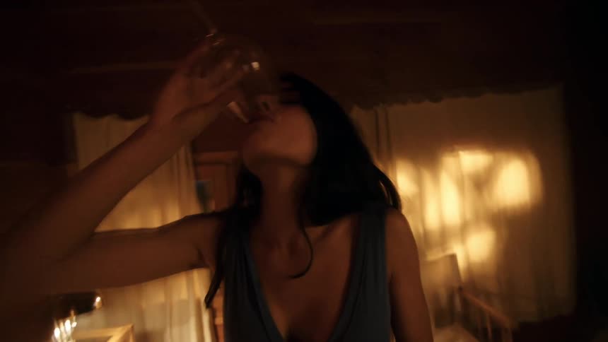 A woman drinks from a wine glass