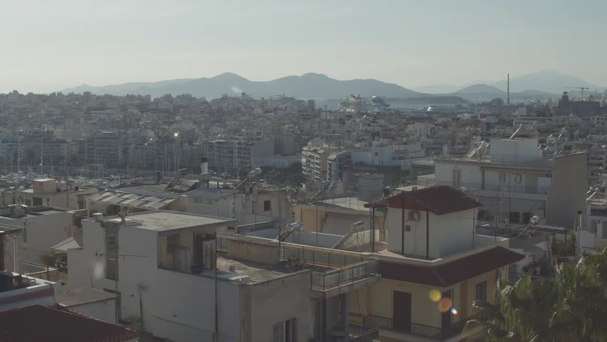 A panoramic view of athens with the acropolis visible in the distance