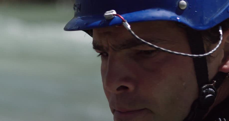 Extreme close-up of a kayaker wearing a blue helmet