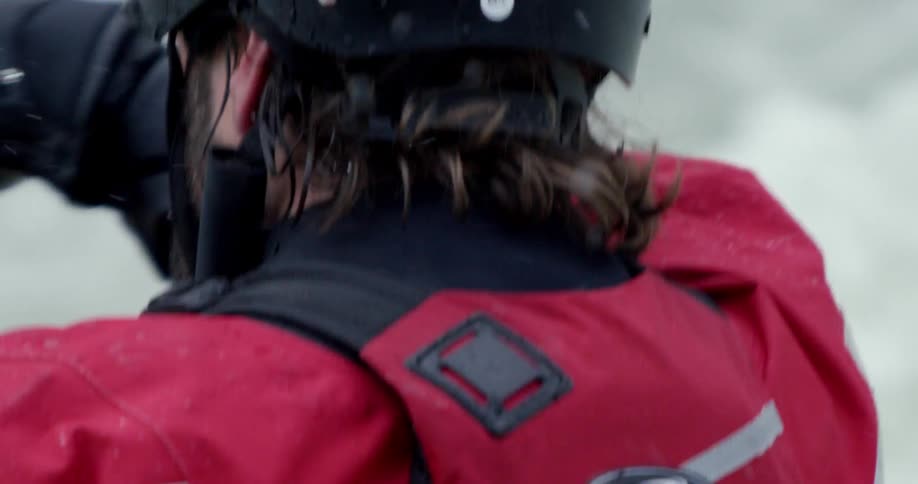 A man is kayaking through rapids