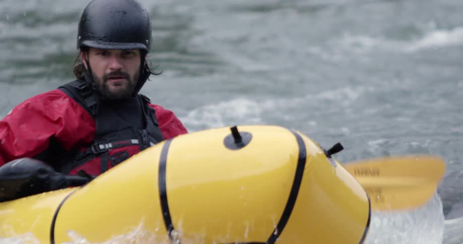 A kayaker floats on a turbulent river