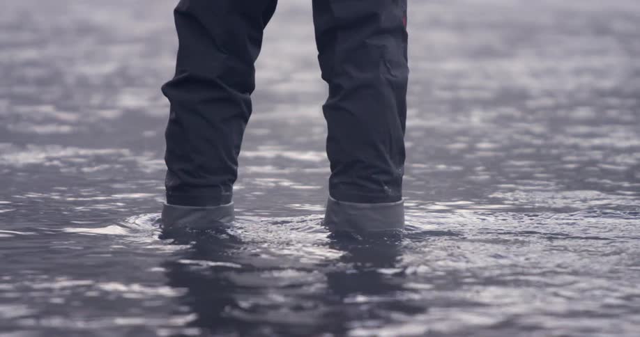 A view of a person standing in shallow water
