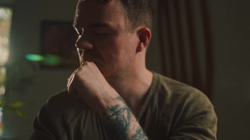 Portrait of a thoughtful man with hand on mouth