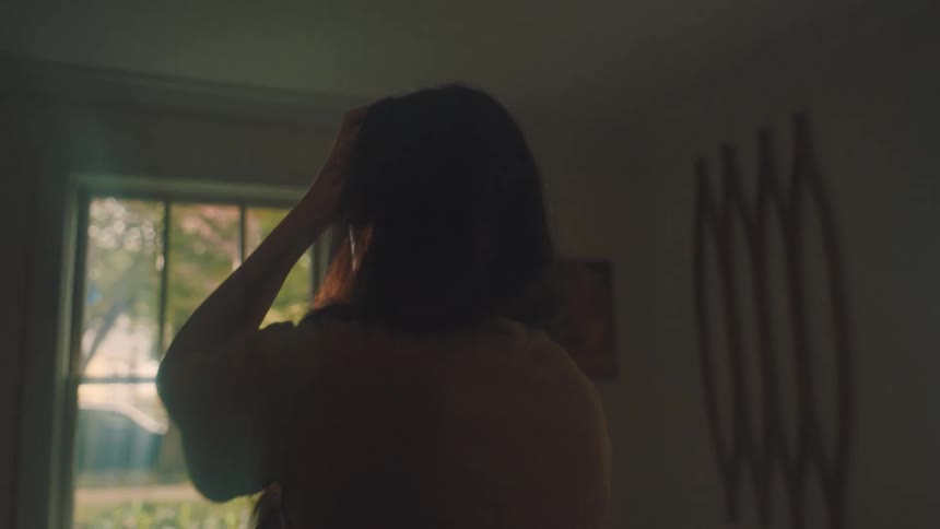 Restless woman running her hand through her hair while on a phone call