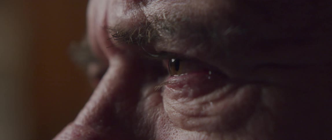 Close up of an elderly mans eyes watering and crying