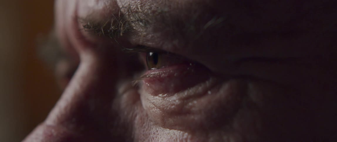 Close up of an elderly mans eyes crying