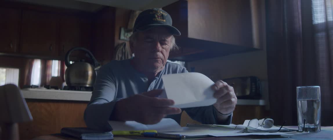 Elderly man sitting at the table and looking at some documents