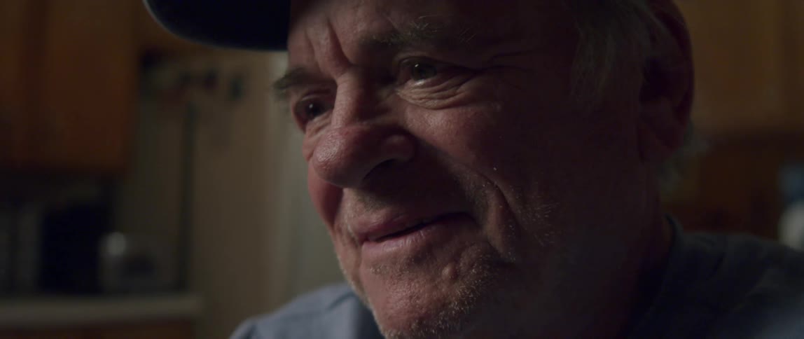 An elderly man with an expression of happiness on his face